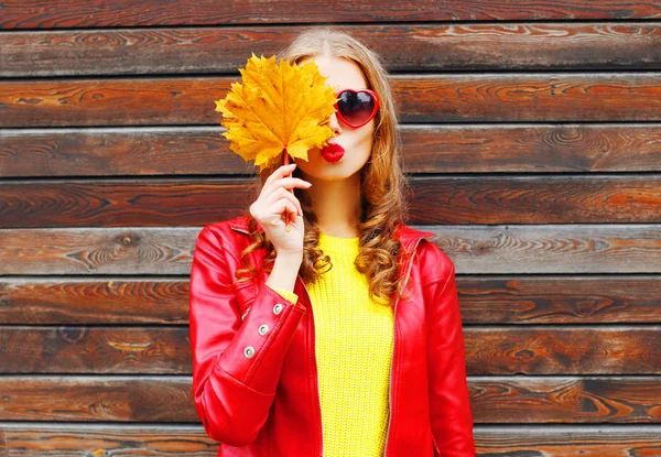 Bonita mulher com outono amarelo bordo folhas sobre backgro de madeira — Fotografia de Stock