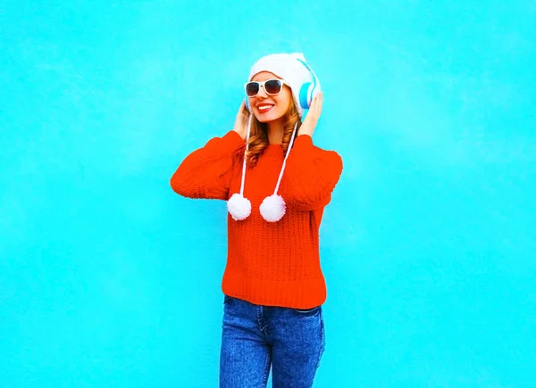 Sonriente mujer joven en suéter rojo, escucha música en inalámbrico — Foto de Stock