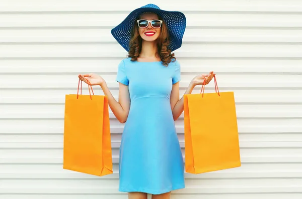 Portrait happy smiling woman holding and showing shopping bags w — Stock Photo, Image