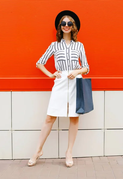 Beautiful young smiling woman with shopping bags wearing white s — Stock Photo, Image