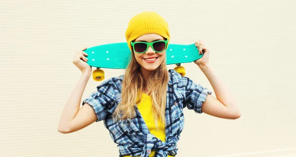 Retrato fresco sonriente mujer con monopatín usando color amarillo — Foto de Stock