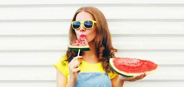 Portrait young woman eating ice cream shaped watermelon over whi — 스톡 사진