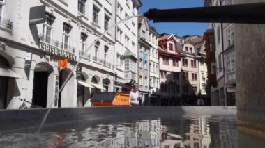 SANKT GALLEN, 7 Mayıs 2020 - St. Gallen, İsviçre 'nin kuzeydoğusundaki Constance Gölü' nün güneyinde yer alan bir şehirdir. Eski şehir merkezinde çeşme ve insanlar yürüyor.