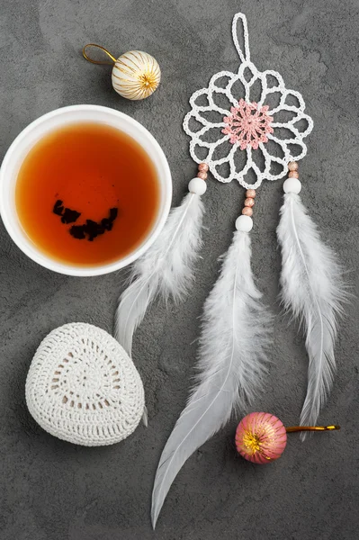 Cup of tea and crocheted pebble — Stock Photo, Image