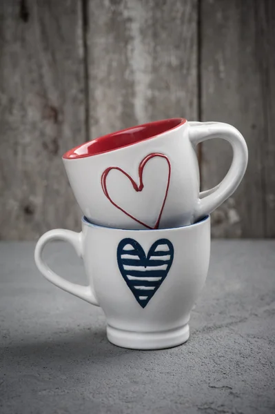 Set of cups with hearts over concrete background — Stock Photo, Image