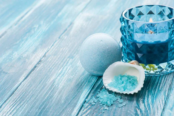 Bath bombs closeup with blue lit candle — Stock Photo, Image