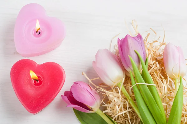 Red pink heart candles and tulips