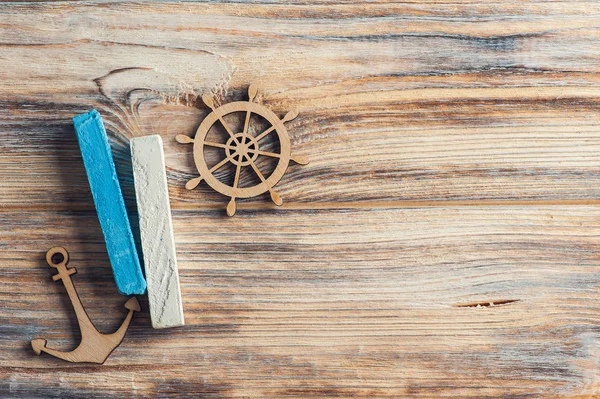 Wooden anchor and steering wheel — Stock Photo, Image