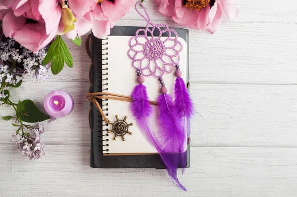 Open notebook, dream catcher, peony and lilac