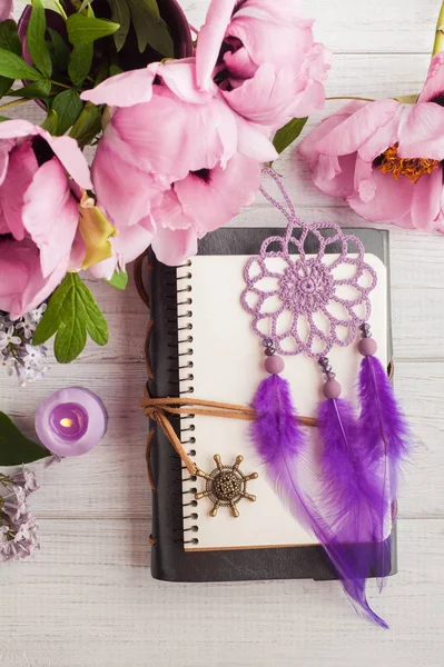 Open notebook, dream catcher, peony and lilac