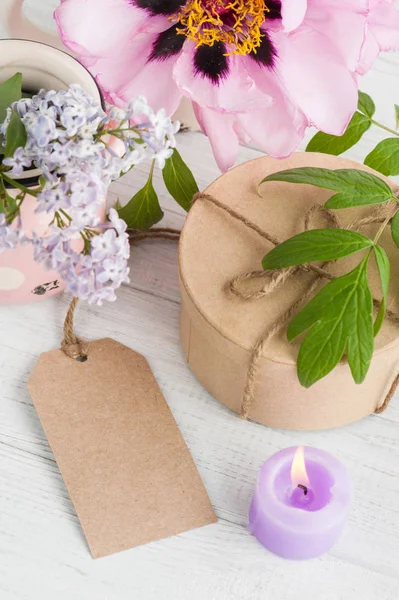 Kraft gift box, pioenrozen en lila bloemen — Stockfoto
