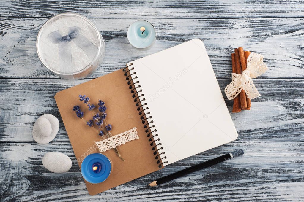 Notebook, lavender flowers, candles, pebble