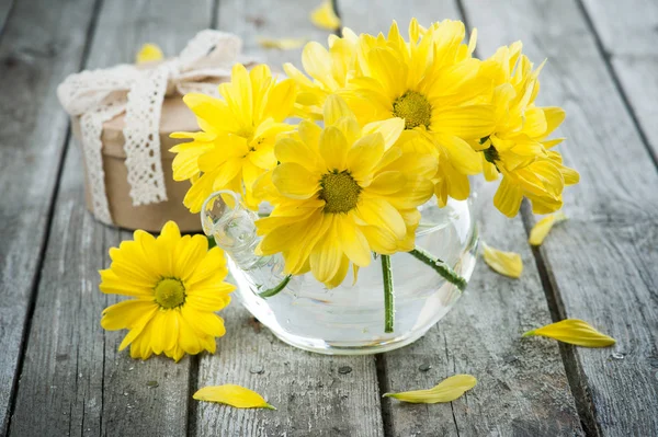 Hand crafted gift and yellow daisies — Stock Photo, Image