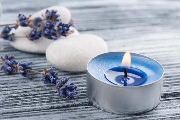 Lavender flowers, blue lit candle