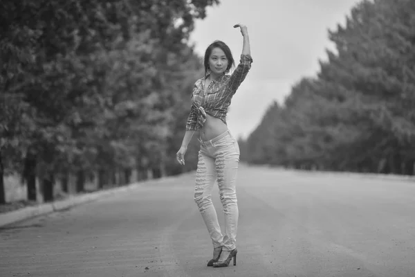 Asian Girl teenager with long legs in a hippie style posing on the freeway — Stock Photo, Image