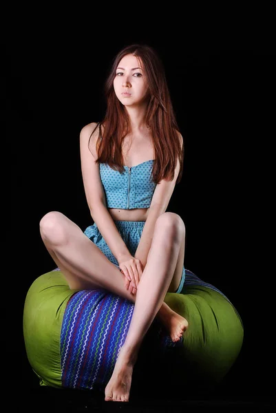 Young asian woman  in a blue dress posing in studio on a black bacground — Stock Photo, Image