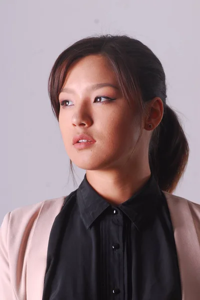 Portrait of an Asian young woman in a business suit — Stock Photo, Image