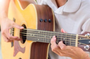 Maske takan ve parkta gitar çalan adam maske takıyor ve covid-19 virüs koruma programında gitar çalıyor.