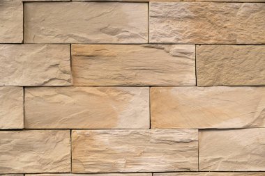 kıvrımlı yüzeyi olan bej kaplamalı fayans. Tuğlalar pürüzsüz dokular.