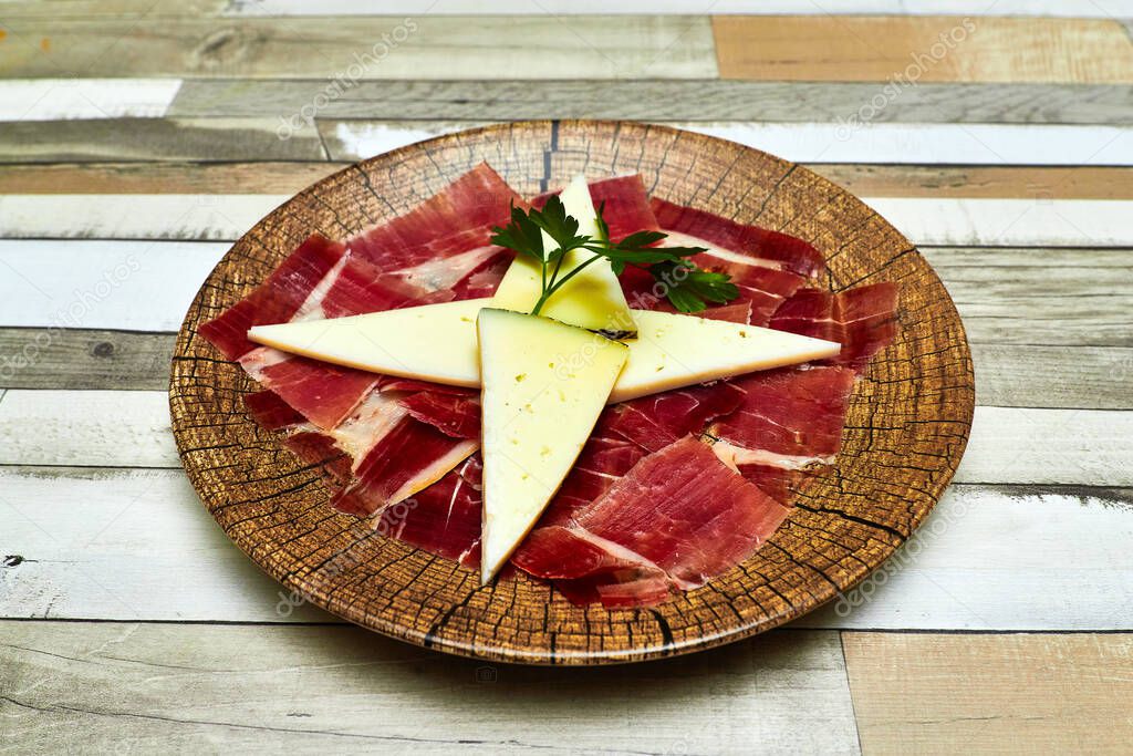 plate of ham with manchego cheese