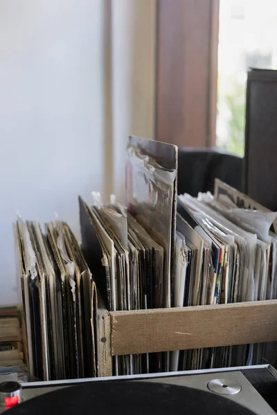 musical records in a stack in a wooden box