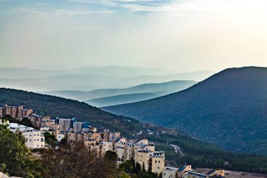 View of Galilee mountains from the Holy city of Safed or Tsfat Israel in the evening. Mountain hills in fog. clipart