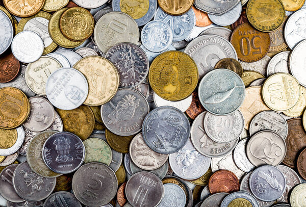 European and world coins background. A collection of various coins from around the world.