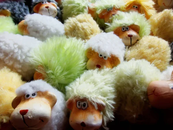 A flock of toy fluffy sheep on a market stall
