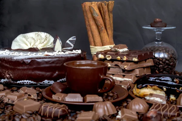 Still-life. Chocolate. Candies. Chocolate cake. Cinnamon. Coffee.