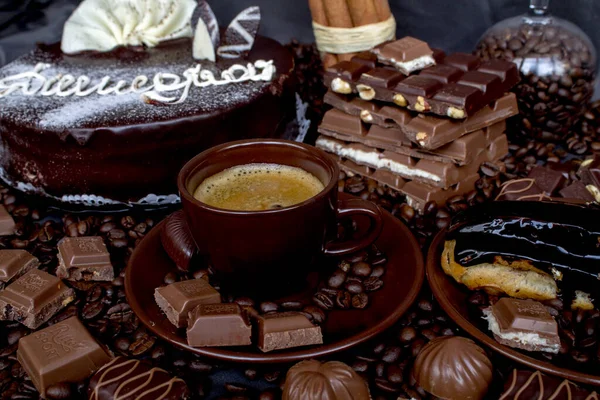 Still-life. Chocolate. Candies. Chocolate cake. Cinnamon. Coffee.