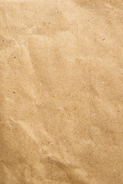 Primer plano del papel artesanal. Vista vertical de un cartón marrón vacío en blanco, espacio de copia para texto — Foto de Stock