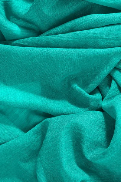 Top view of crumpled green fabric. Vertical empty textile background — Stock Photo, Image