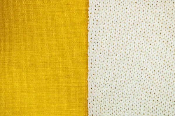 Hintergrund aus zweiteiligem gelben Textil und weißem Strickstoff, Kopierraum. — Stockfoto