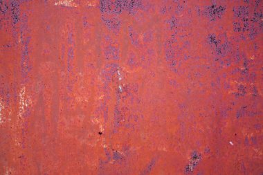 Background of rusty iron wall with cracked red paint