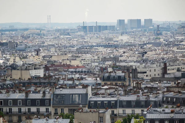 Paris city scape of rooftops. Buildings of Paris from high point of view. Various roofs and houses of Paris