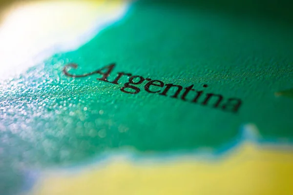 Shallow depth of field focus on geographical map location of country Argentina in South American continent on atlas