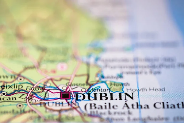 Shallow depth of field focus on geographical map location of Dublin city in Ireland United Kingdom Europe continent on atlas