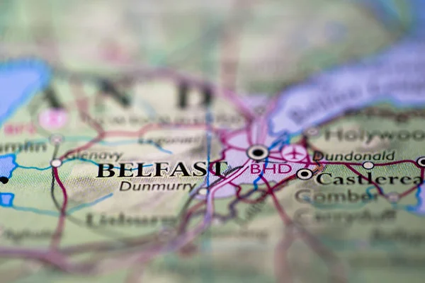 Shallow depth of field focus on geographical map location of Belfast city in Northern Island United Kingdom Europe continent on atlas