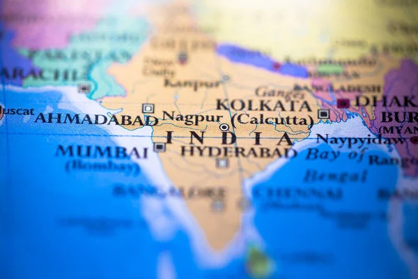 Shallow depth of field focus on geographical map location of country India in Asia continent on atlas