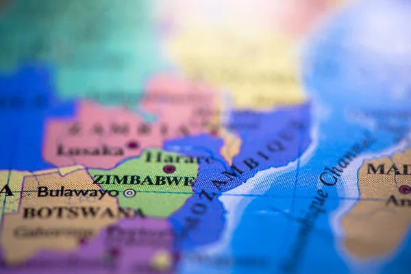 Shallow depth of field focus on geographical map location of country Zimbabwe in Africa continent on atlas