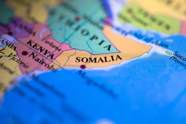 Shallow depth of field focus on geographical map location of country Somalia in Africa continent on atlas