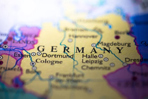 Shallow depth of field focus on geographical map location of country Germany in Europe continent on atlas