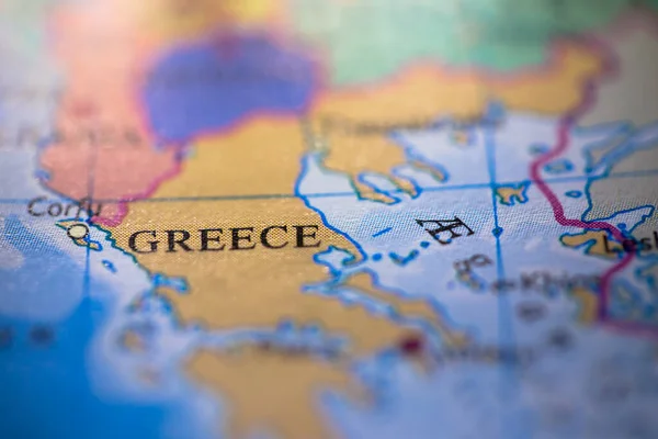 Shallow depth of field focus on geographical map location of country Greece in Europe continent on atlas