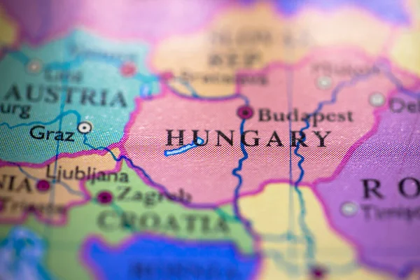Shallow depth of field focus on geographical map location of country Hungary in Europe continent on atlas