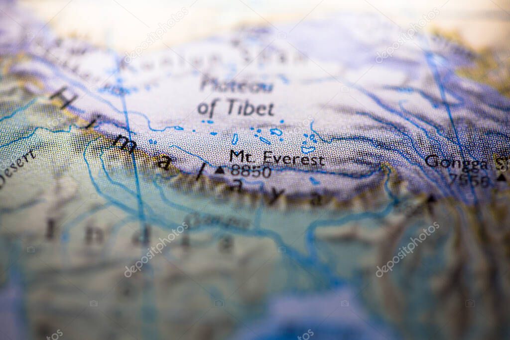 Shallow depth of field focus on geographical map location of Mount Everest in Nepal in Asia continent on atlas