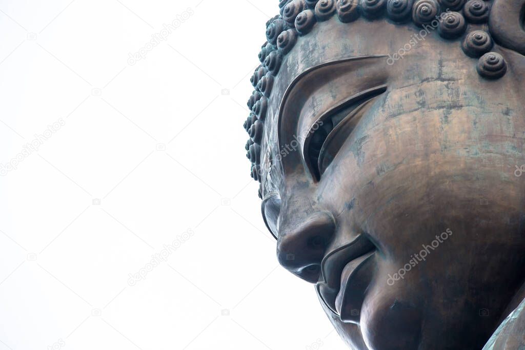 Large bronze statue of Buddha Shakyamuni with negative white background space