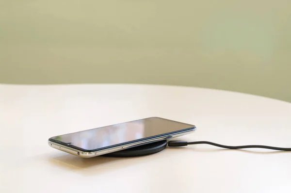 Smartphone wireless charging on induction charger. Wireless charger. Copy space