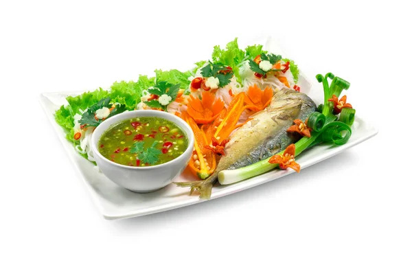 Fried mackerel (Maing-PLA-too) and fresh vegetables serving with Thai rice small noodles and seafood sauce deepping Thai appetizer salad Thai style side view