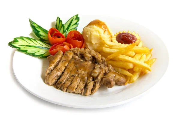 Pork steak slice and mash potato,frenchfries decorate with carved cucumber and tomato on plate fusion american style  side view isolated on white background