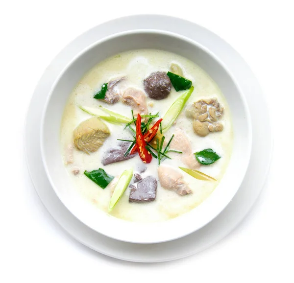Chicken with coconut milk soup (Tom kha gai) Thaifood curry style in white bowl top view isolated on white background
